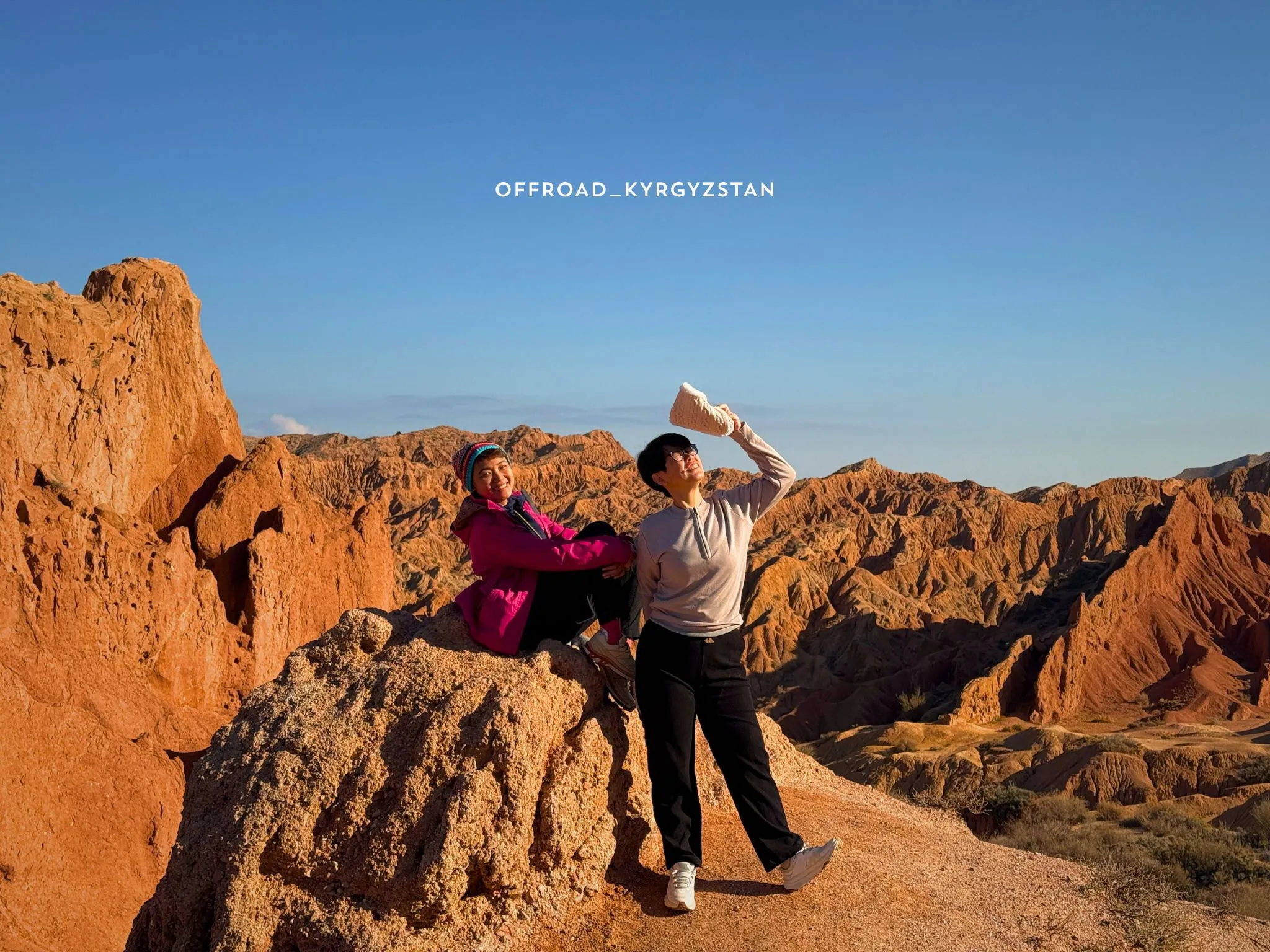 Indonesian guests on a sightseeing adventure tour at Skazka Canyon, exploring the fairytale red rock formations.