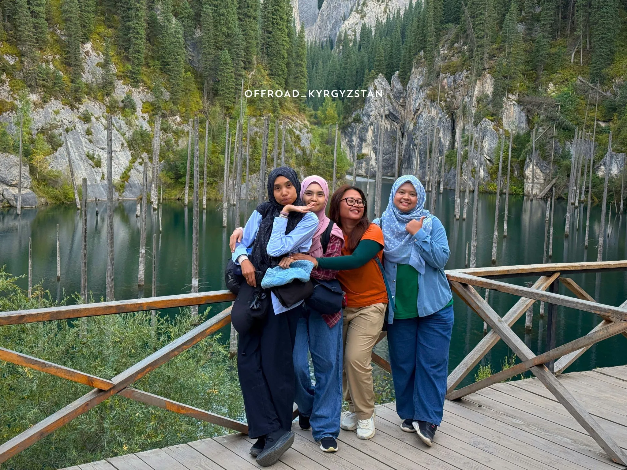 Group of Malaysian guests enjoying a jeep tour at a scenic mountain lake in Kyrgyzstan