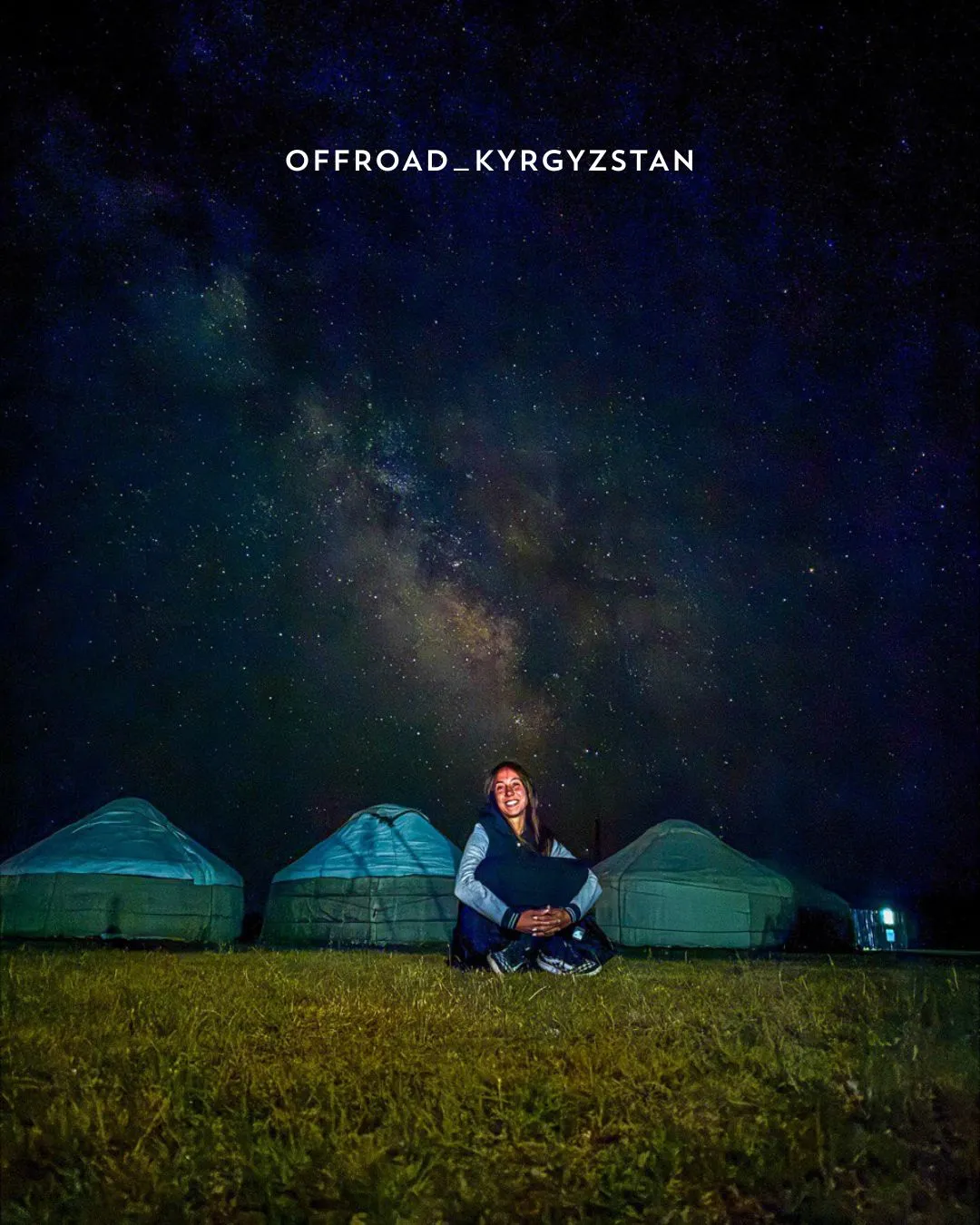 A european tourist woman enjoying a stargazing night during a premium jeep expedition at Son-Kul lake yurt camp.